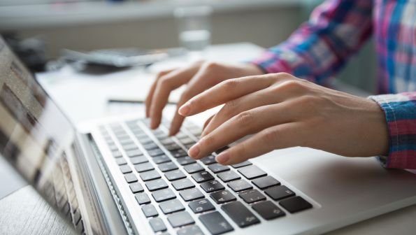 laptop vs chromebook differences, woman typing on computer