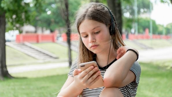 childs first phone, teen on phone, what age to get a phone