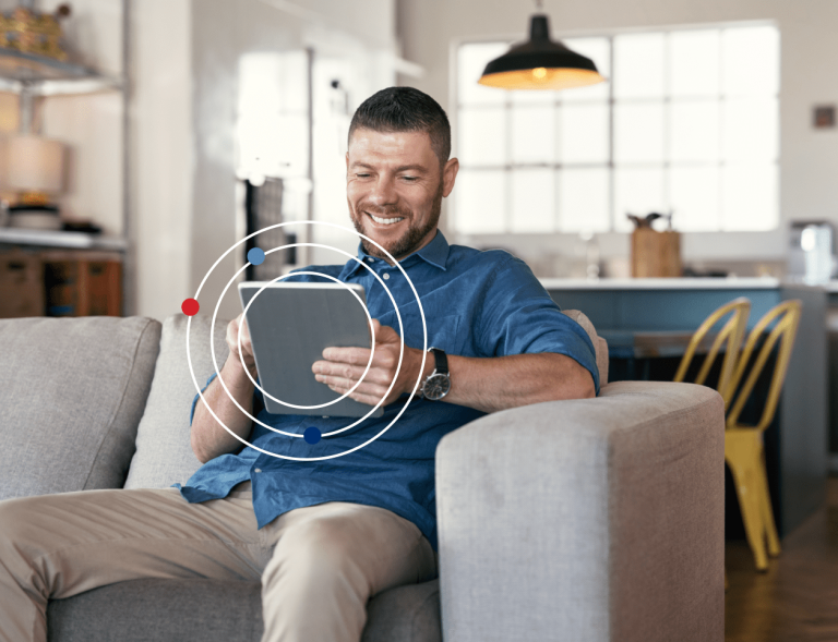 Man on couch using tablet